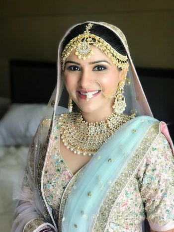 Photo of Happy bride shot in pastel blue lehenga