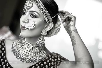 Photo of Black and white shot of bride adjusting nosering