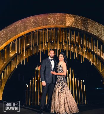 Glam couple portrait on sangeet with gold decor