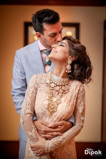 Peach gown with layered necklace on engagement