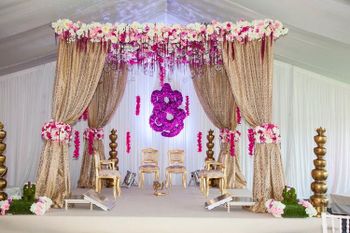 Photo of Indoor mandap decor in pink and white with drapes