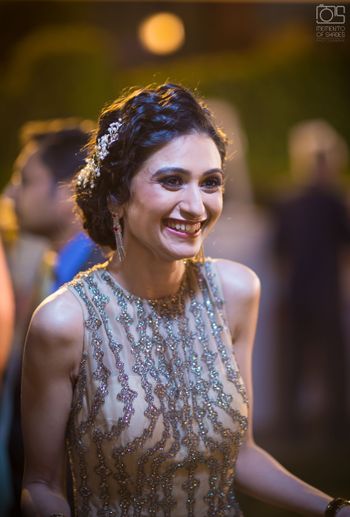 Engagement hairstyle with side bun and embellished pin