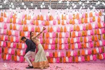 Bright and colorful tassel stage decor for mehendi or sangeet