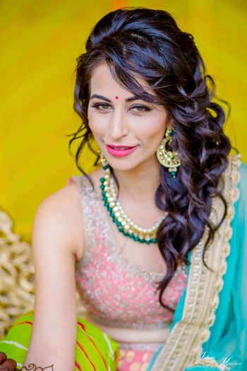 Mehendi hairstyle side swept wavy hair