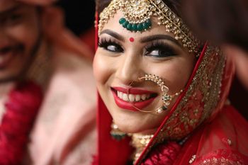 Photo of Happy bride with long lashes and Nath