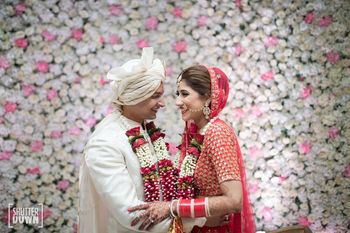 Photo of Happy couple shot against floral wall