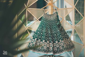 Dark green lehenga on hanger 