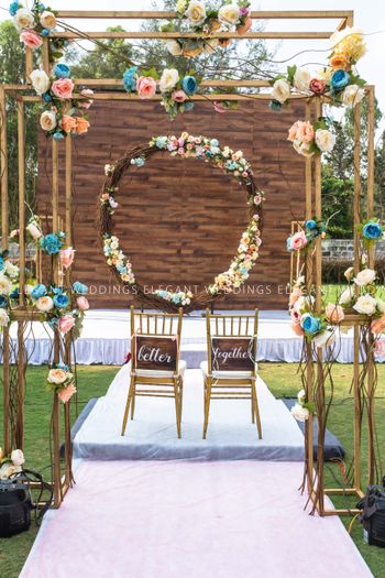 Photo of Floral wreath and couple chairs with simple mandap
