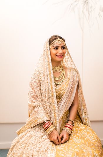 Photo of Bride in yellow lehenga, with double dupatta