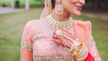 Pearl and kundan bridal haathphool with peach lehenga 
