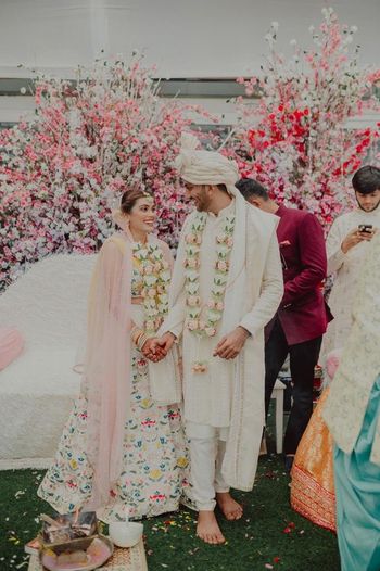 Photo of Bride and groom coordinating in white.