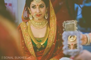 bride looking through the mirror shot