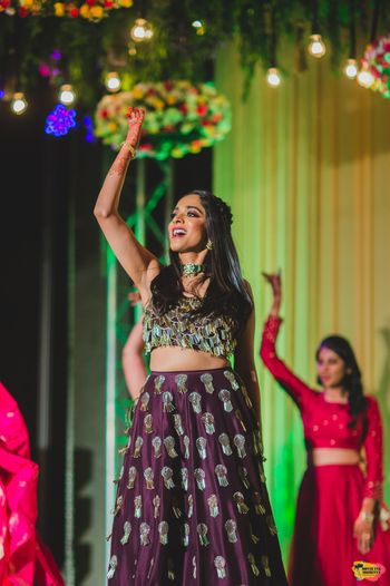Dancing bride on her sangeet in maroon lehenga 