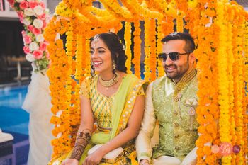 Photo of A bride and groom in Mehendi.