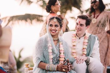 Photo of A smiling couple portrait, with the bride and groom in offbeat colors!