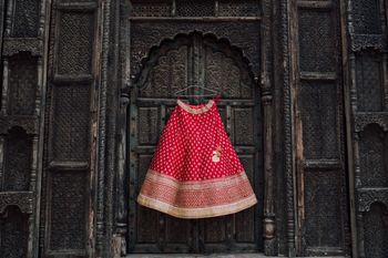 Photo of Red Bridal Lehenga on a Hanger