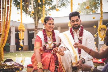 Photo of Bride & groom getting married & smiling wide throughout