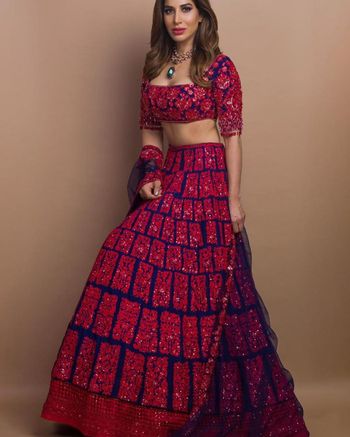 Photo of Fully embellished red and navy blue lehenga.