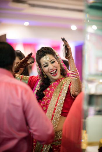 Fun bridal portrait with bride in red saree
