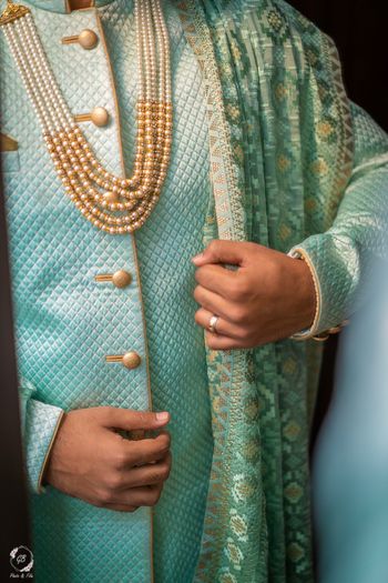 light blue sherwani details with groom necklace