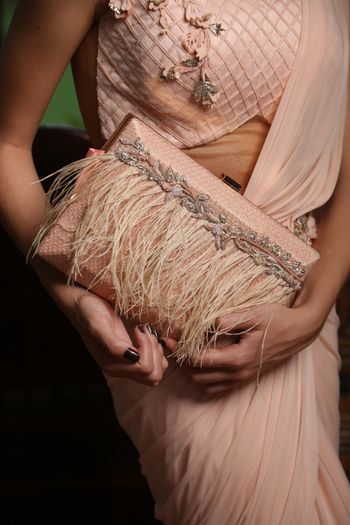 Photo of Blush pink fringe clutch