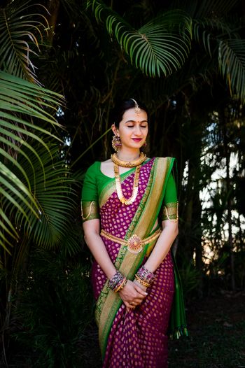 A south Indian bride dressed in purple and green saree
