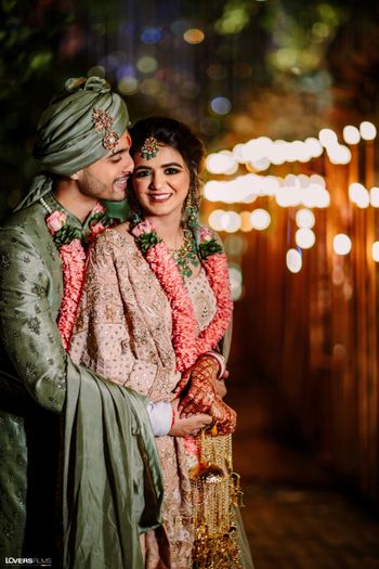 pretty bride and groom shot with groom in grey sherwani