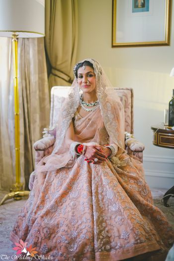 Photo of Peach and gold pastel bridal lehenga