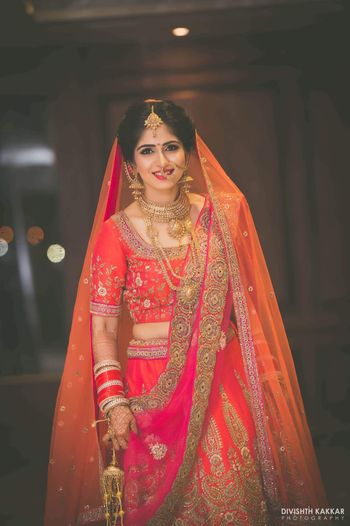 Bride in Orange Pink and Red Lehenga