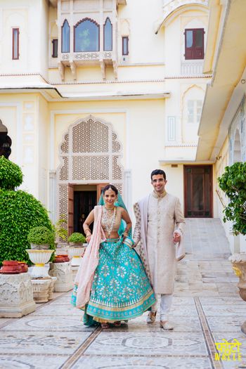 Groom with bride wearing light blue bridal lehenga