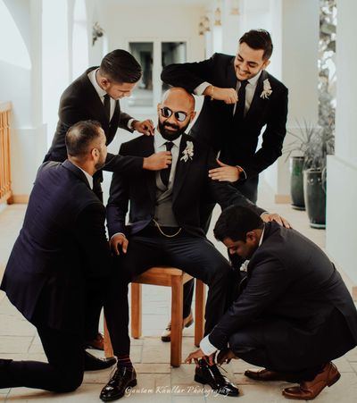 Photo of groom with his groomsmen getting ready shot