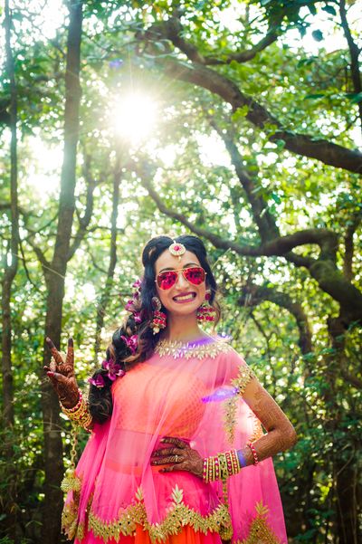 Photo of Bride to be in sunnies on mehendi day