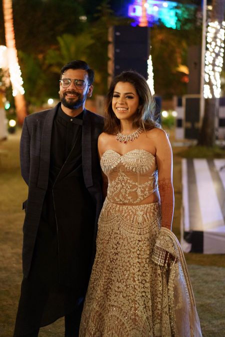 bride wearing nude and ivory manish malhotra gown for her cocktail