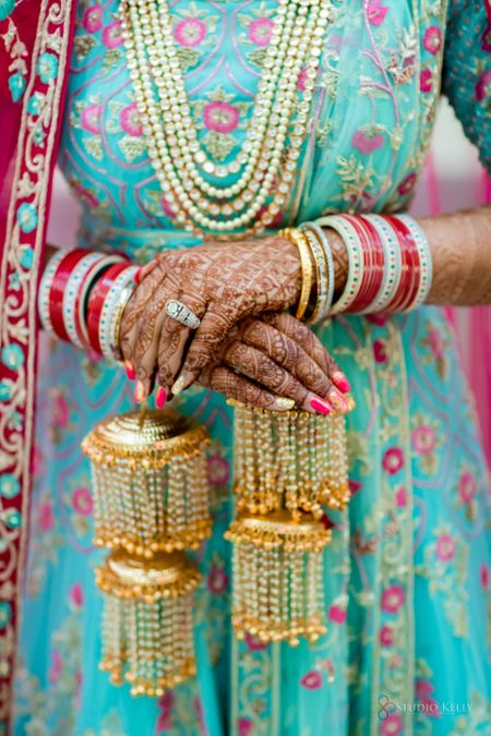 bridal hands with kaleere and a red chura