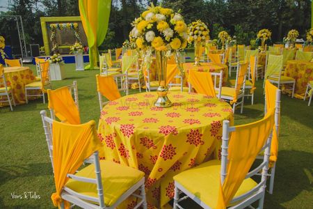 Mehendi decor ideas with yellow table setting 