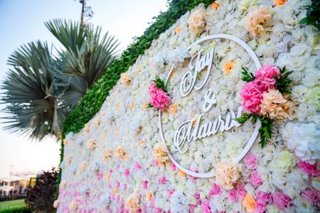 floral wall with couple names in decor