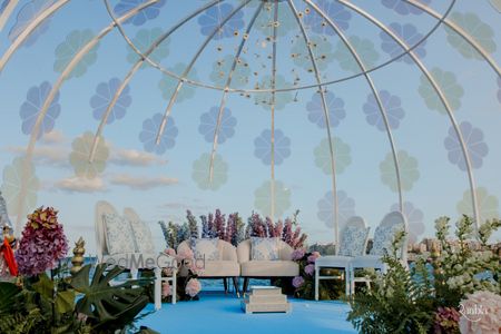 Photo of Super unique stained glass mandap with floral decor for an outdoor day wedding