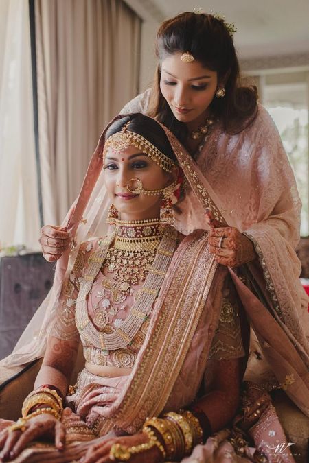 Sister of a bride helps help with the dupatta