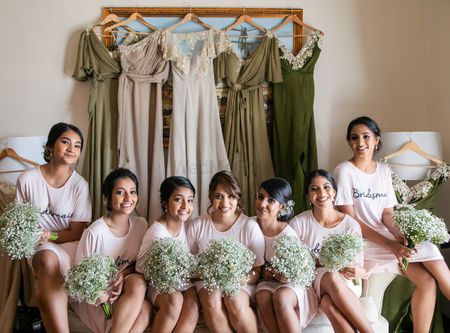 Bridesmaids with dresses on hanger 