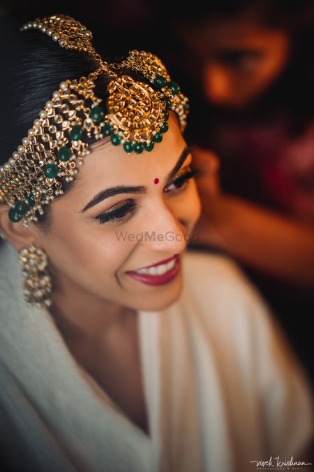 Photo of Gorgeous bridal mathapatti with green beads