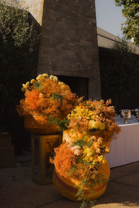 Photo of Gorgeous floral table decor in yellow and orange hues in a statement style