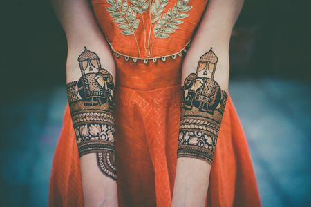 A bride shows her mehendi to the camera