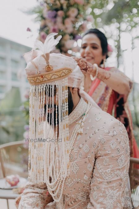 Photo of Lovely all pearl groom sehra with a ivory safa for the wedding day