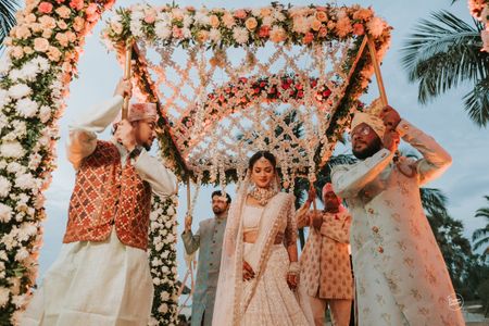 bride entering under phoolon ki chadar with her brothers