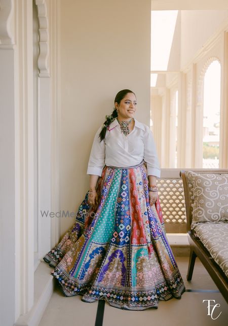 Photo of Fun multi-panelled colourful skirt with a white shirt and colourful choker for the sister of the groom look