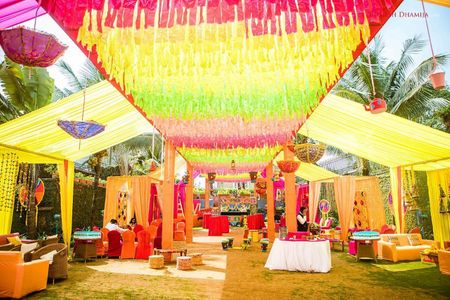 Colourful mehendi tent decor idea with buntings