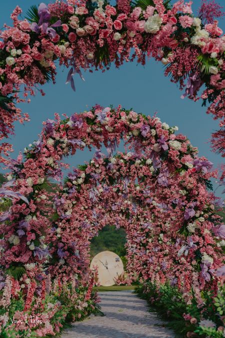 Photo of Beautiful shot of arch-style entrance decor with pink and white florals