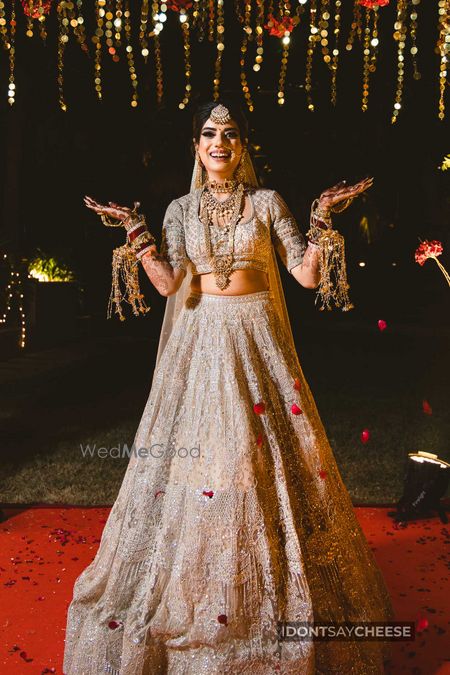 Photo of Bride dressed in an ivory lehenga.