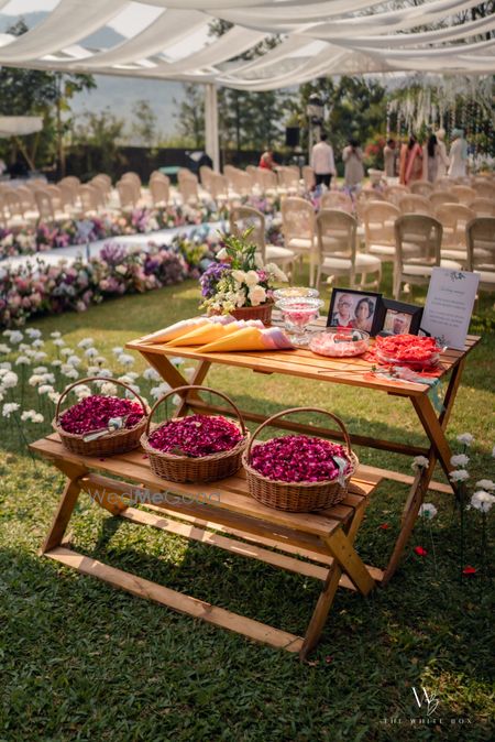 Lovely memory table with petal baskets at an outdoor wedding 