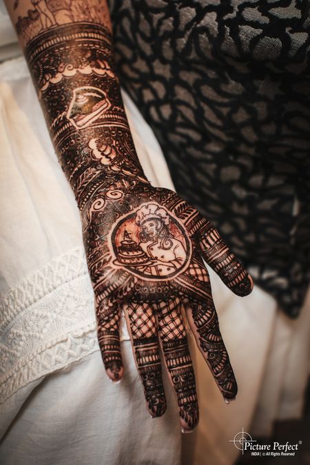 personalised mehendi design on bridal hands